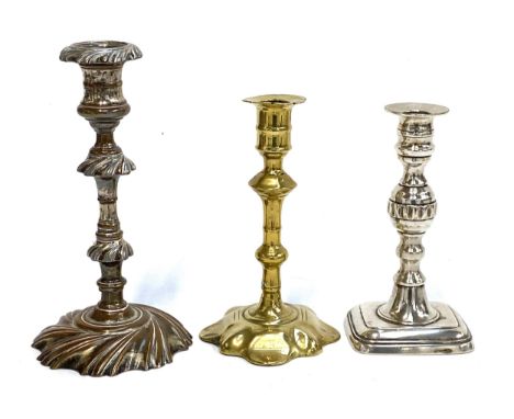 An 18th century brass candlestick on petal base, c.1750, 19.5cmH; together with an 18th century silver plated copper candlest