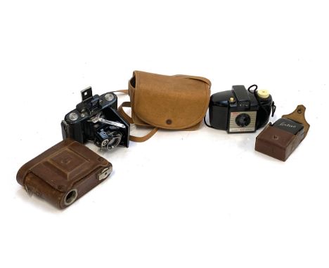 Photographica: A Kodak Brownie 127; A Super Ikonta Zeiss Ikon bellows camera; and a Lixtus light meter 