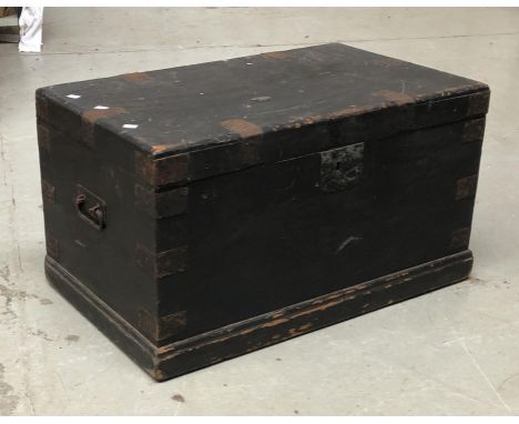 A 19th century black painted pine trunk with metal bracings and twin carry handles, 76x45x42cmH