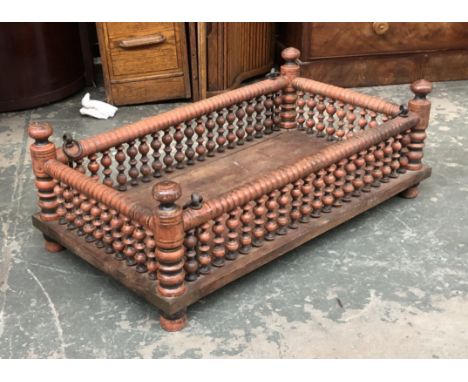 A red painted bobbin-turned Indian cradle, 97x52x33cmH