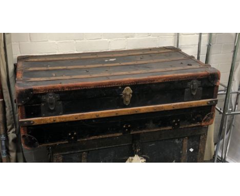 An antique canvas, leather and wood banded travel trunk, 102cmW