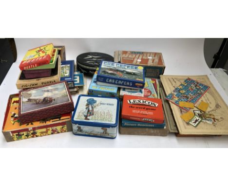 A large quantity of toys, board games and puzzles in two boxes to include Scrabble, Mickey Mouse toy lantern outfit, etc