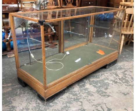 An early 20th century oak and glazed shop counter/display cabinet, bearing plaque Premier Shop Fitters, London EC1, with meta