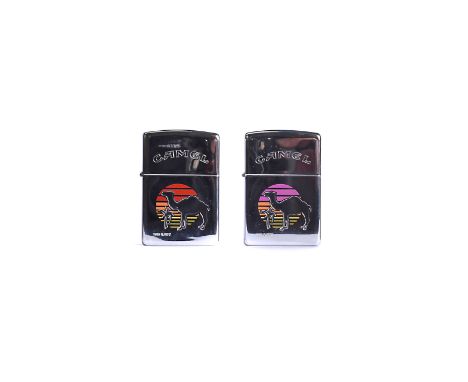 A Camel Desert Sunset Prototype Zippo Lighter, with pink, orange and yellow background on polished chrome, together with anot