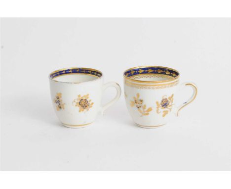 Two Caughley porcelain coffee cups circa 1790-95, decorated in underglaze blue and overglaze gilding in the Dresden Flowers p