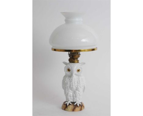 A Continental porcelain oil lamp circa 1880-1890, possibly Ernst Bohne &amp; Sohne, modelled as a single white owl with glass