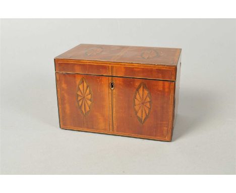 A Regency mahogany veneered tea caddy, of rectangular form with a hinged lid opening to reveal a lidded two-divisional interi