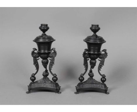 A pair of French Empire style brass candlesticks, the drop-in sconces with pierced shell bases over stepped circular bowls, b