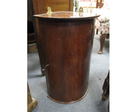 A 19th century mahogany bow fronted corner cupboard with copper jam pan, together with other copper items, a mahogany trug an