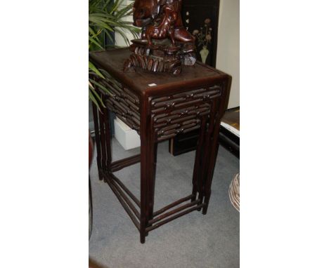 A nest of three hardwood tables, each of the rectangular tops above chain link aprons, the shaped cylindrical legs running do