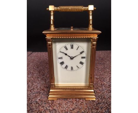 A French gilt brass carriage clock with repeat, the pillared case with silvered platform lever escapement and painted dial   