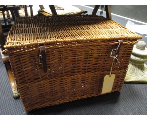 A large wicker hamper with leather strap buckles, 39 x 60 x 41cm and another smaller (2)  