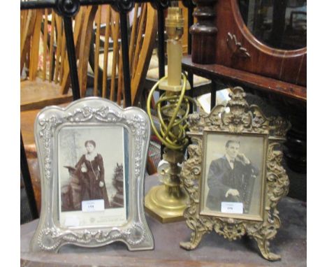 A set of andirons, a brass lamp, two photograph frames etc  