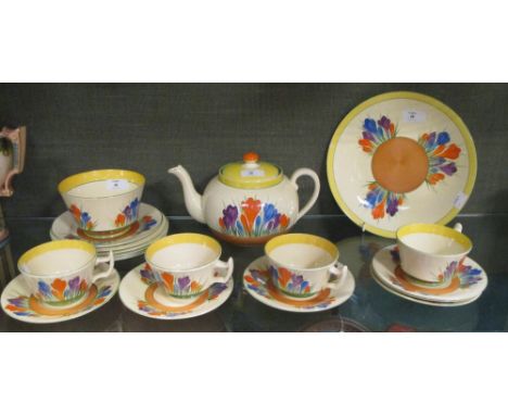 A Clarice Cliff crocus pattern teapot, four teacups, sugar bowl, six saucers, six side plates and a sandwich plate  