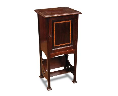 An early 20th century mahogany bedside cabinet, the inlaid cupboard door opening to reveal a pipe rack and shelf within above