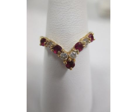 An 18ct ruby and diamond wishbone ring, size P, together with three bar yellow and rose gold gate bracelet with heart shaped 