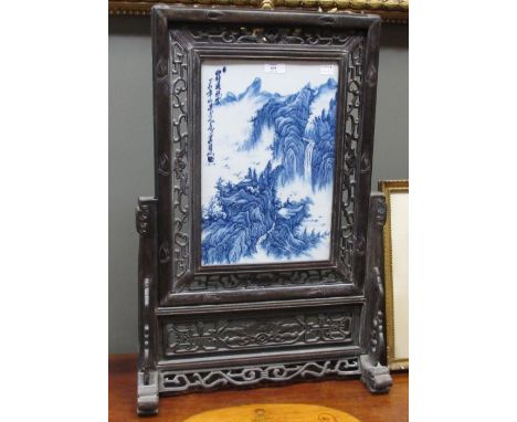 A 20th century blue and white table screen in a hardwood surround, together with a Chinese wall mirror (2)  