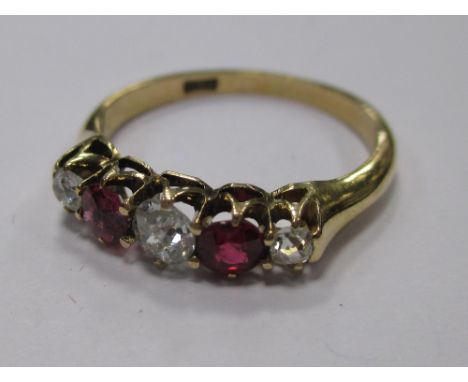 A five stone ruby and diamond ring, the slightly graduated stones all claw set in yellow metal stamped 18ct, size M  