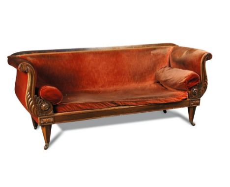 A William IV rosewood framed sofa, the lyre shaped ends with leaf carved decoration, upholstered in a faded pink fabric, loos