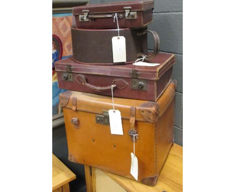 A square trunk with brass studded sides and leather corners, 42 x 50 x 43cm, together with two suitcases and a circular hat b