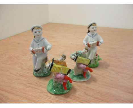 Two similar Lomonosov models of sailors playing accordions, 13.5cm high and two similar Dulevo figures of seated accordion pl