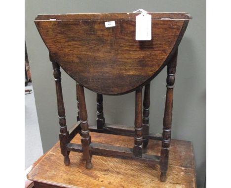 An oak drop leaf table, together with a piano stool and a brass standard lamp  