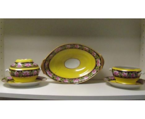 An early 19th century English service, possibly 1820's Coalport, each piece painted with a black ground band of pink roses en