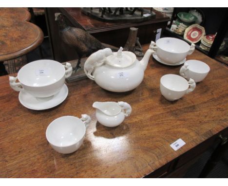 A Spode white porcelain tete a tete teaset, the handles modelled as cats and teddy bears 