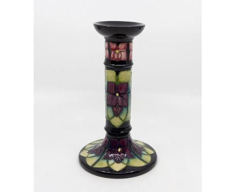 A Moorcroft Violet pattern candlestick, contemporary, impressed marks and WM initials to base, approx 21cm highCondition: goo