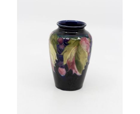 Moorcroft Leaf and Berry baluster vase, circa 1945, marked and signed to base, 10 cms tallCrazed but otherwise in good condit