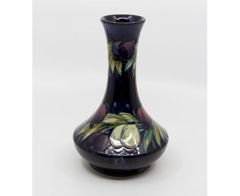 Moorcroft Wisteria pattern vase in squat body with long slender neck, circa 1925, signed and marked to base, 21 cms tallCraze