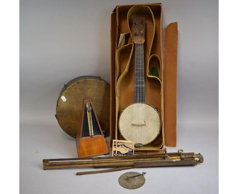 A Vintage Four String Banjo Ukulele in Cardboard Box, A Tambourine, a Music Stand and a Clockwork Metronome (Working but Miss