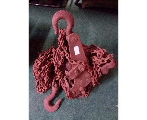 A vintage chain block and tackle.