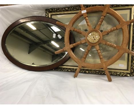 A wall hanging mirror, a picture and a ships wheel thermometer.