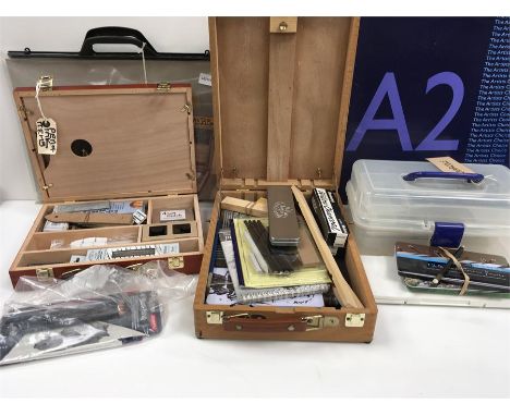 A folding easel with handle, a wooden boxed charcoal set, watercolour pencils and sketch pads.
