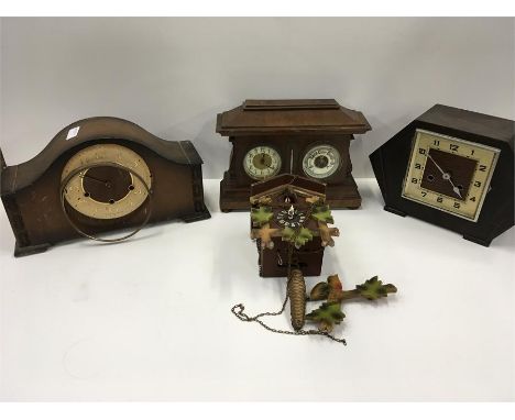 Two wooden mantle clocks, a wooden clock and barometer together with a cuckoo clock.