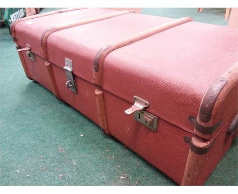 A wood bound travel trunk. 