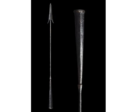 Ca. 100–300 AD. Roman. An iron pilum spearhead with a barbed, triangular blade, and a long, narrow neck, and a robust flaring
