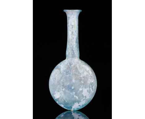 Ca. 100–300 AD. Roman. A finely blown flask in a light-blue coloured glass. The vessel features a flat, spherical body, a lon