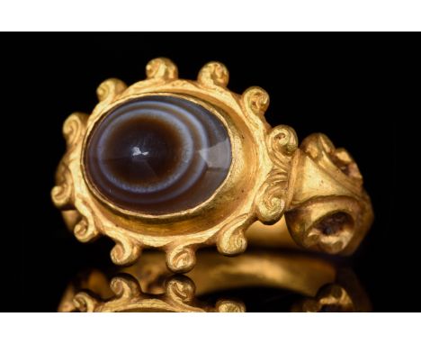 Ca. 50–200 AD. Roman. A gold ring with a circular band flaring towards the shoulders, which are decorated with scrolls. The f