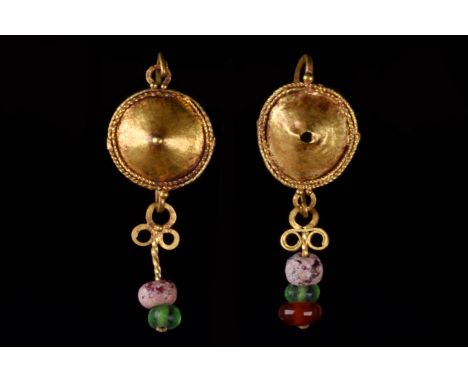 Ca. 100–300 AD. Roman. Two gold earrings, each with a shield framed by twisted wire centered by a large granule, joined to th