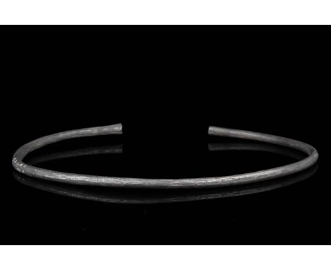 Ca. 900–1100 AD. Viking Age. A fine silver, circular bracelet with gently flaring terminals. In Viking society, arm rings and