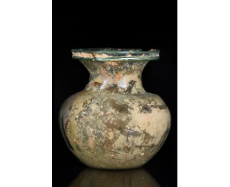 Ca. 200–300 AD. Roman. A free-blown sprinkler flask of transparent green glass with a spherical body, dipping at the shoulder