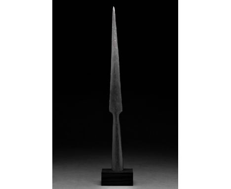 Ca. 300–500 AD. Roman. An iron spearhead with an elongated leaf-shaped blade, raised midrib, sharp tapering edges, and a long
