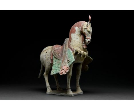 Ca. 386–534 AD. Northern Wei Dynasty. A finely hollow-moulded terracotta horse statuette modeLled standing foursquare on a re