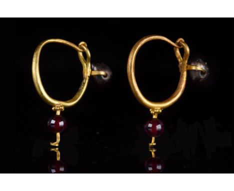 Ca. 100–300 AD. Roman. A matching pair of gold earrings with a circular band with a hook-and-clasp closure. Below the closure