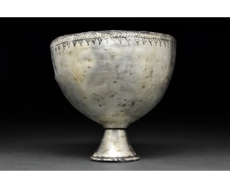 Ca. 400 - 200 BC. Hellenistic . A beautiful silver cup with a hemispherical bowl and an added conical foot. The rim is decora