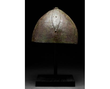 Ca. 900–1100 AD. Viking Age. An iron helmet comprising four triangular curved iron plates with bands outside supporting the s