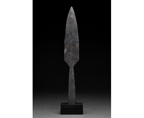 Ca. 300–500 AD Roman. An iron spearhead comprising a slender tapering leaf-shaped blade with a raised midrib and a long, flar