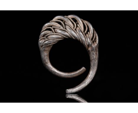 Ca. 900–1100 AD. Viking Age. A beautiful twisted silver ring made by interweaving four circular silver hoops and applied twis